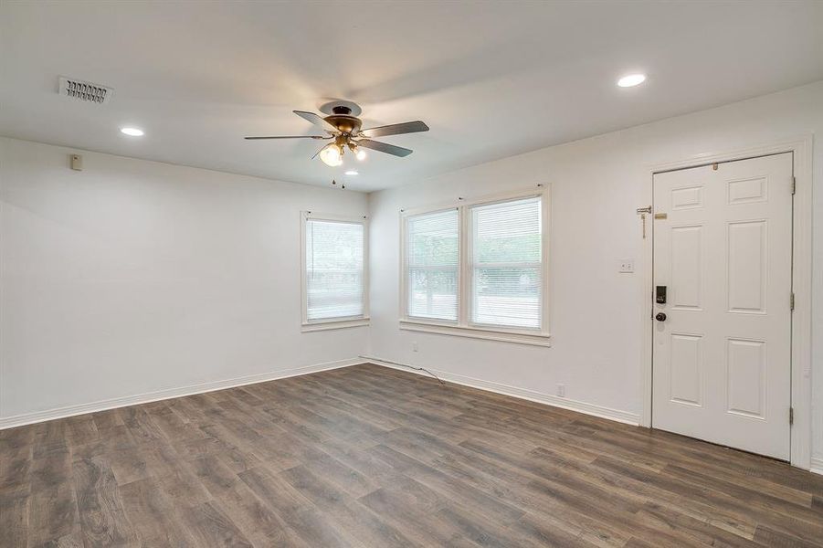 Living room with recessed lighting, dark wood-style floors, and ceiling fan