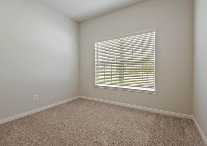 Secondary bedroom with lush carpet flooring