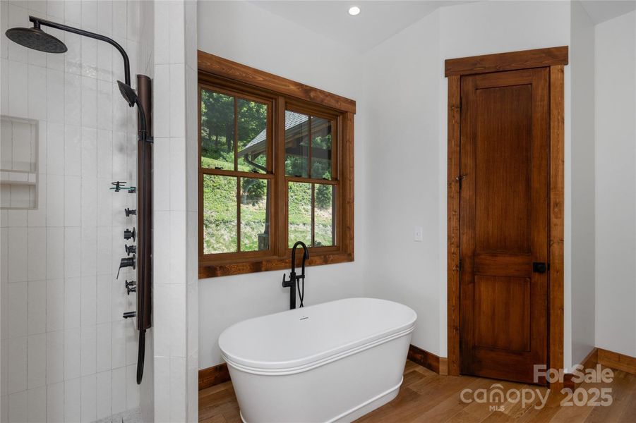 Main floor primary suite with incredible mountain views, access to porch & 2 walk-in closets. Primary bathroom with double vanities & backlit mirrors, soaking bathtub, shower & water closet.