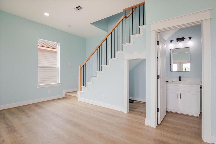 Beautiful trimmed out staircase leading to upstairs bedrooms. Notice the storage area under the stairs!