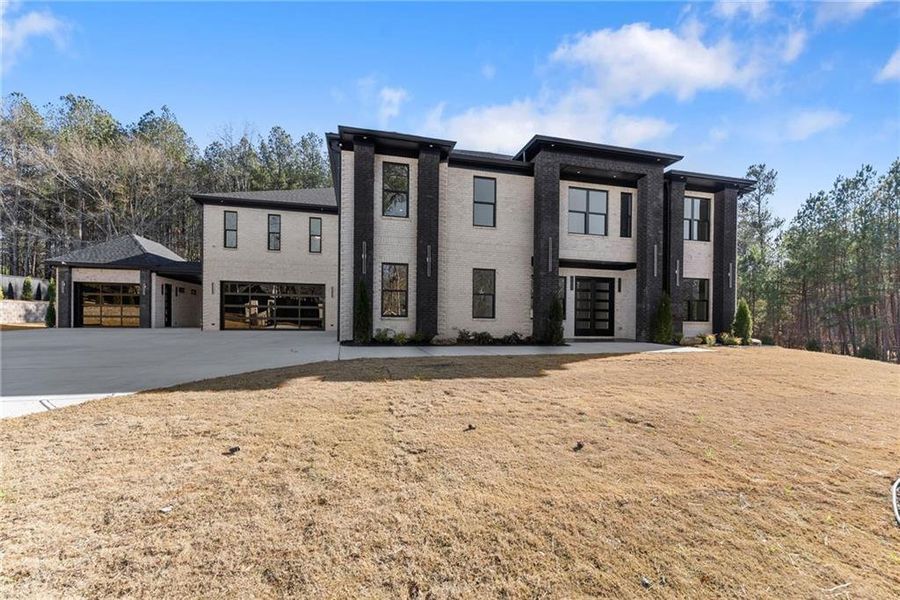 Front exterior of a new home in , Hoschton, GA, highlighting curb appeal (Image 33).