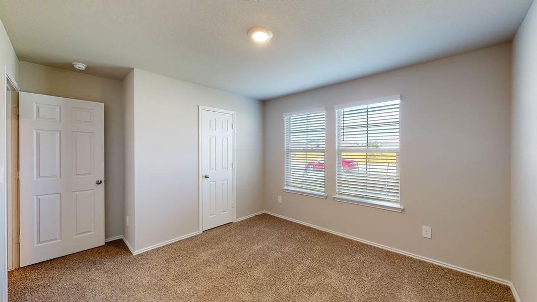 Unfurnished bedroom with carpet and a closet