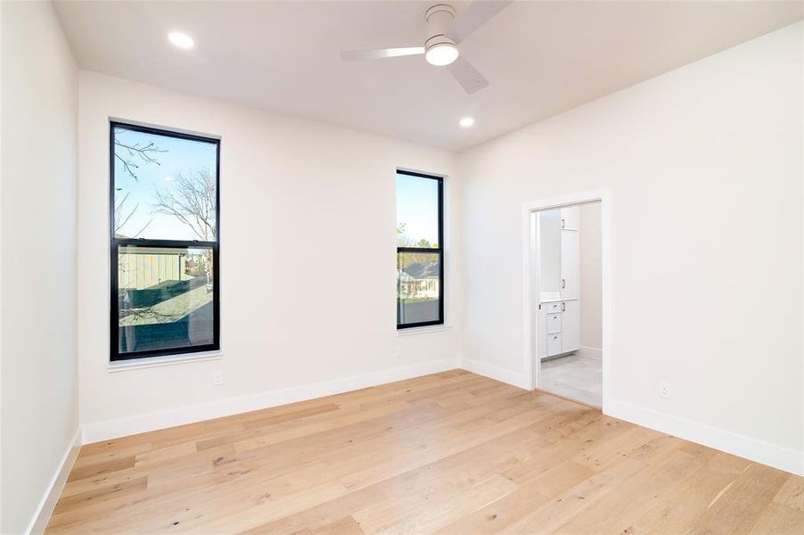 Unfurnished room featuring ceiling fan and light hardwood / wood-style floors