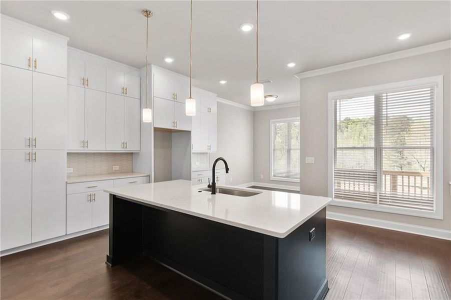 The Jacobsen II kitchen offers so much storage with stacked cabinets to the ceiling. Photos are not of the exact property but are similar, the home is currently under construction.