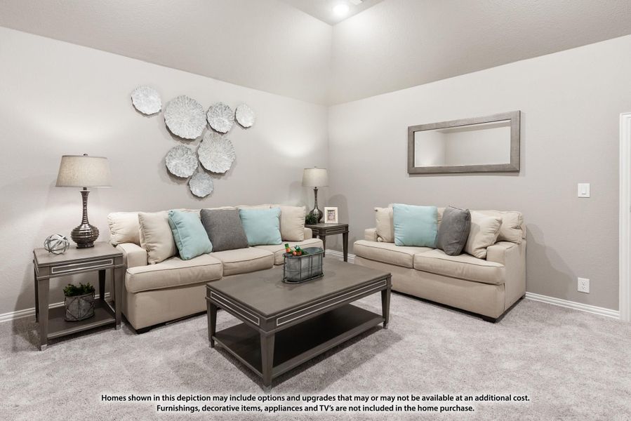 Living room with two beige sofas, gray coffee table, and vaulted ceiling with decorative wall art Living room with two beige sofas, gray coffee table, and vaulted ceiling with decorative wall art
