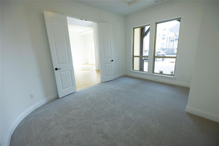 Unfurnished bedroom with carpet flooring and baseboards Unfurnished bedroom with carpet flooring and baseboards