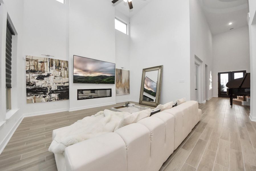 Open-concept living room with high ceilings and contemporary finishes.