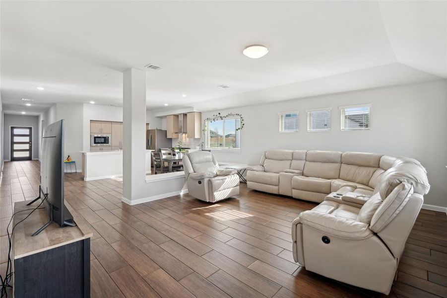 Living room with dark wood-type flooring