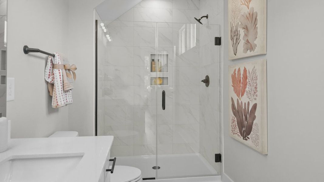 Spacious primary shower in the Summit home plan with stylish tile and elegant finishes.