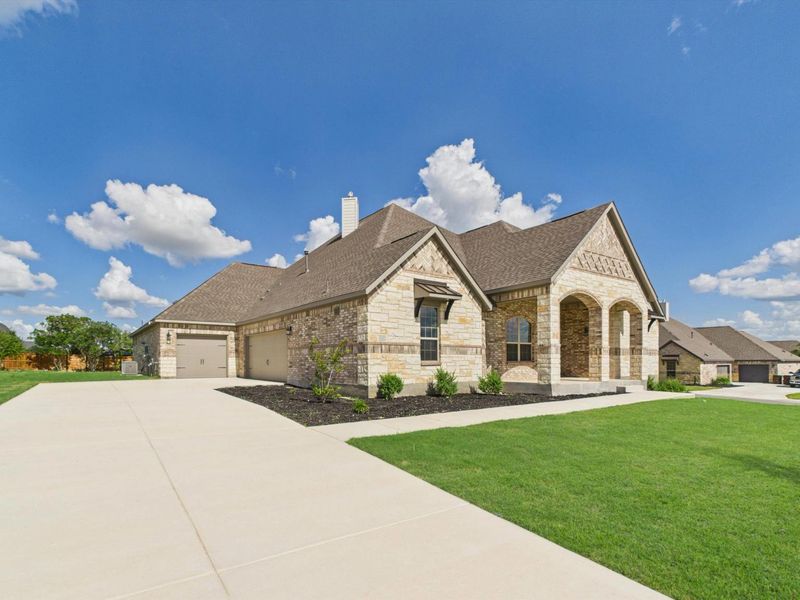 Front exterior of a new home in Potranco Oaks, Castroville, TX, highlighting curb appeal (Image 26).