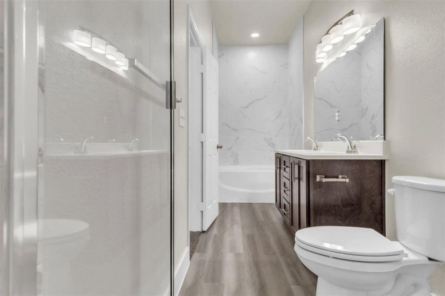 Primary bath with separate tub and spa shower with seat