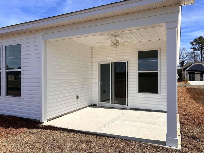 Rear view of property with ceiling fan and a patio area