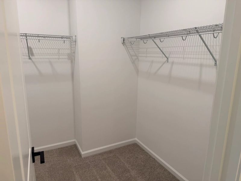 Primary Walk-In featuring the AW Collection® Serene - Open storage with understated design. Primary Walk-In featuring the AW Collection® Serene - Open storage with understated design.