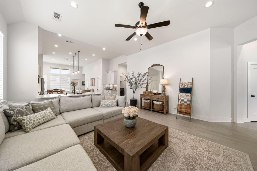 The family room exudes effortless comfort and sophistication, featuring a stylish ceiling fan with integrated lighting that creates an inviting ambiance for intimate evenings and refined everyday living.