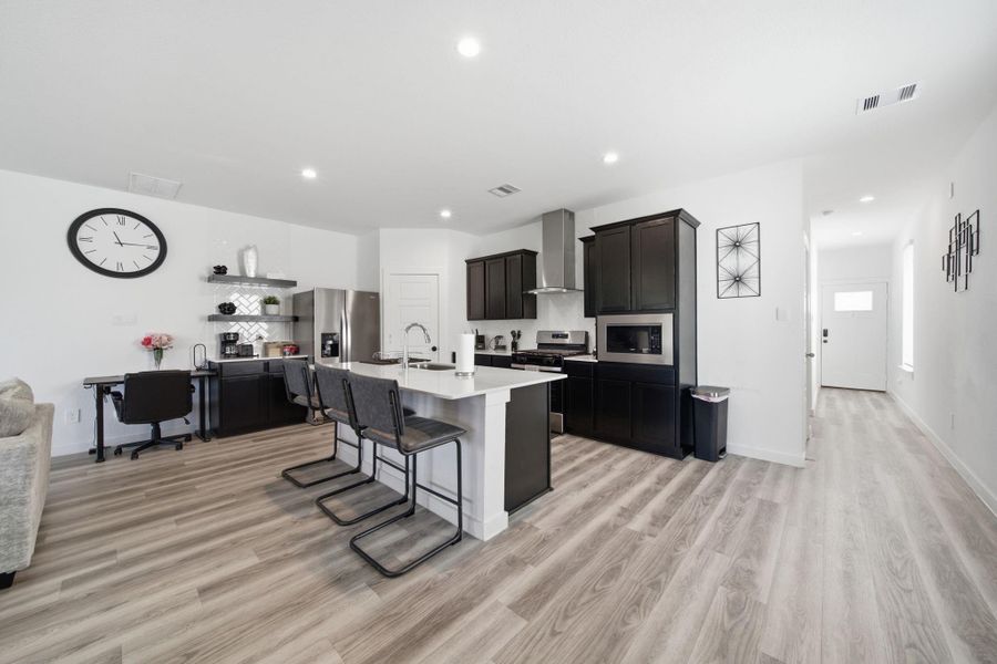 Beautiful, modern open-concept kitchen and living area, thoughtfully designed for comfortable living and effortless entertaining.