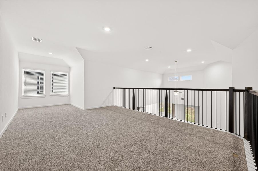 Upstairs, you’ll find 2 additional spacious bedrooms with walk-in closets, a full bath with quartz counters and a tub/shower combo, and a large game room overlooking the family room, complete with a sunny nook perfect for a reading or office area. The upstairs balcony is accented with elegant wrought iron spindles and wood banisters for a luxurious touch.