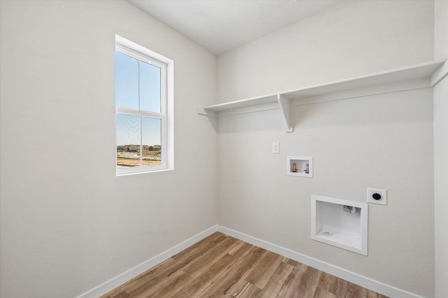 A room with a window and a wood floor.
