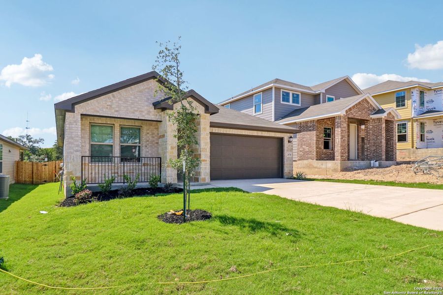 Front exterior of a new home in Scenic Crest - Premier Series, Boerne, TX, highlighting curb appeal (Image 23). Front exterior of a new home in Scenic Crest - Premier Series, Boerne, TX, highlighting curb appeal (Image 23).