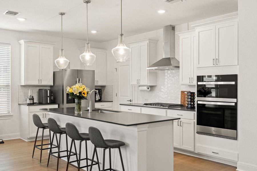 Bright and airy kitchen with upgraded pendant lighting and tile