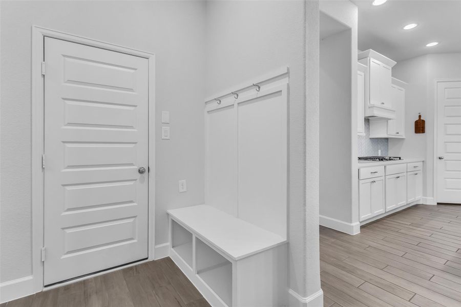 Mud room next to garage door