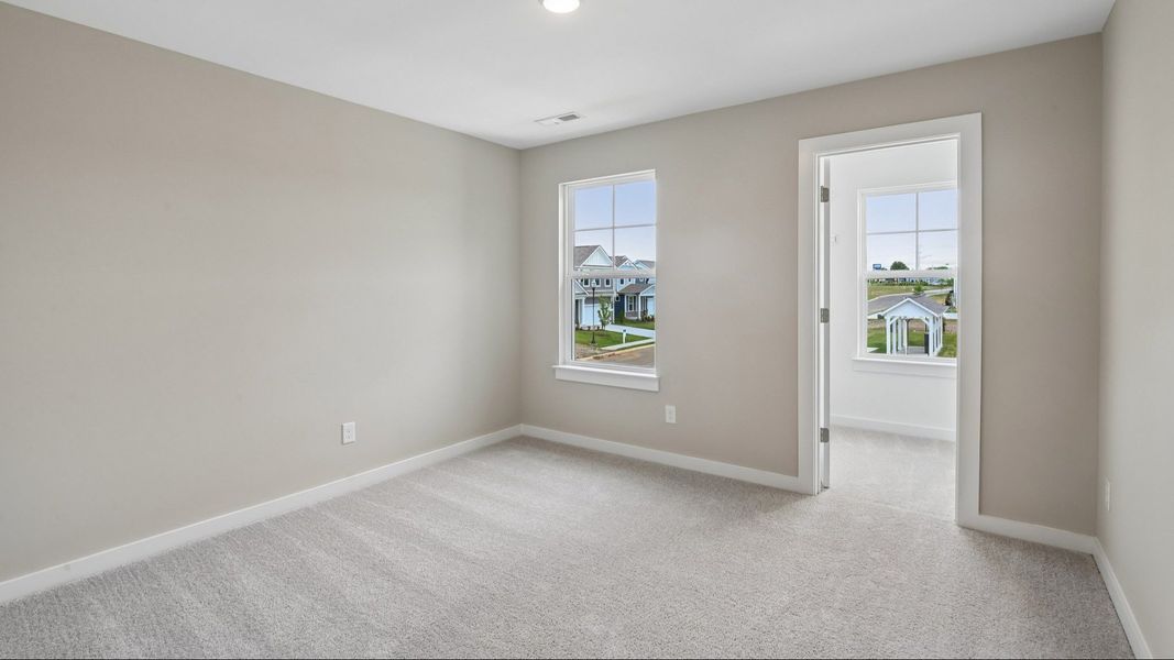 Bedroom with walk-in closet and window