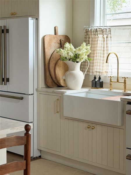 Farmhouse-style apron-front sink with custom made cabinets and sunny window over the sink Farmhouse-style apron-front sink with custom made cabinets and sunny window over the sink