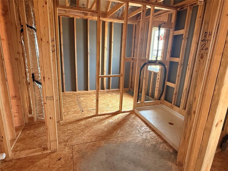 Primary bathroom with double sink vanity, walk in shower and closet