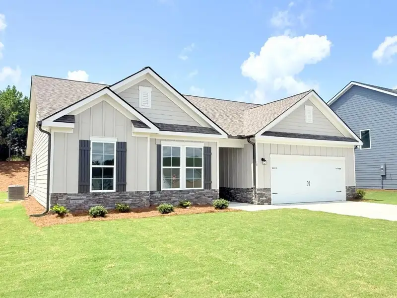 Front exterior of a new home in Sutton’s Landing, Statham, GA, highlighting curb appeal (Image 2). Front exterior of a new home in Sutton’s Landing, Statham, GA, highlighting curb appeal (Image 2).