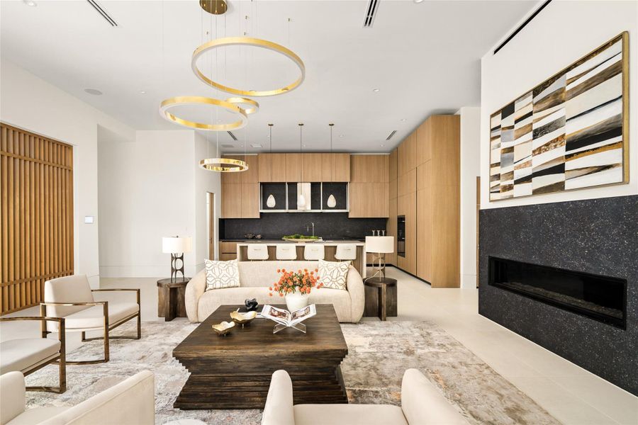 Architecturally driven living space with bold lighting and a seamless transition into the kitchen, ideal for modern living.