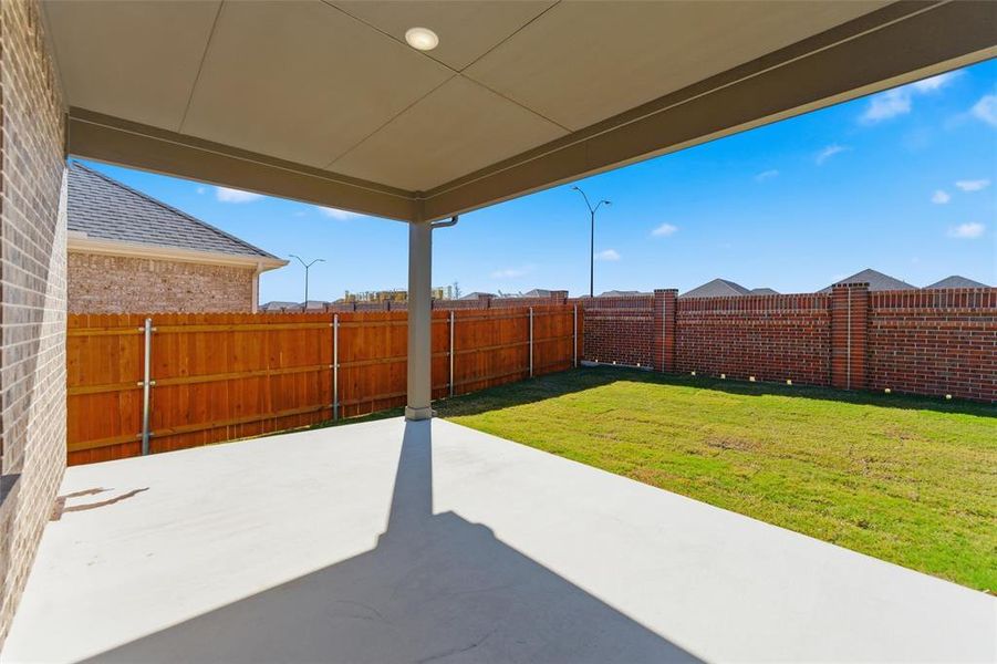 Fenced backyard featuring a patio