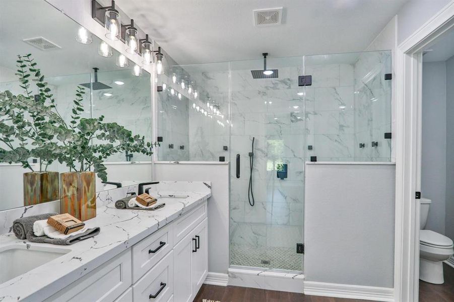 Emarkably Renovated With Contemporary Style. Walk-in primary shower with seamless glass, rainhead shower and multiple body sprayers for a luxurious experience.