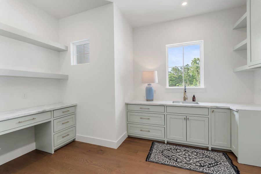 Room for full-size washer and dryer, plus additional counter space for folding and prep. Finished with wide-plank wood flooring and upgraded hardware for a clean, polished look.