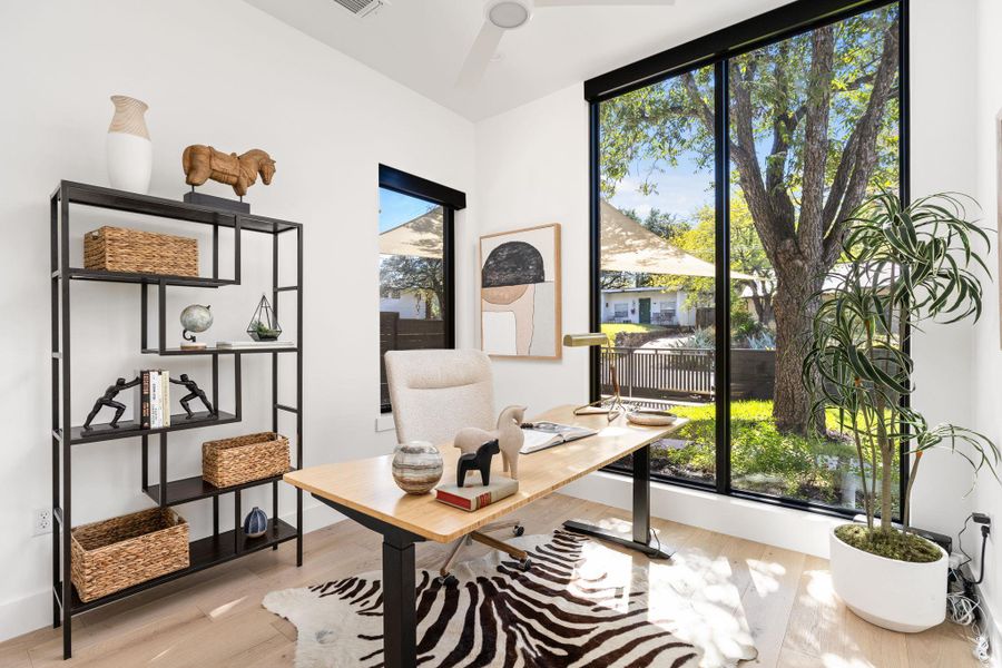 Office space featuring light wood-style floors and ceiling fan Office space featuring light wood-style floors and ceiling fan