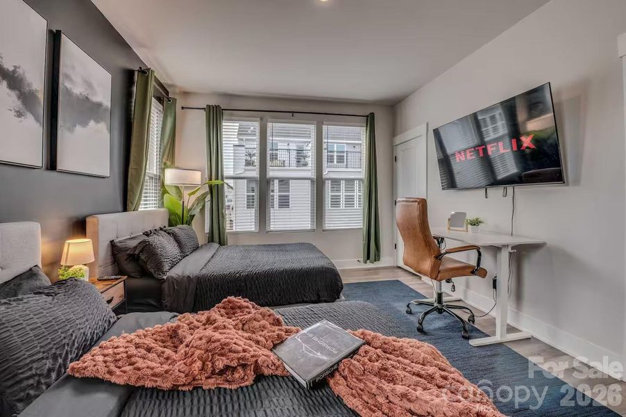 The spacious secondary bedroom offers abundant natural light, generous closet space, and room for multiple beds, making it ideal for guests, family, or a flexible home office setup. The spacious secondary bedroom offers abundant natural light, generous closet space, and room for multiple beds, making it ideal for guests, family, or a flexible home office setup.