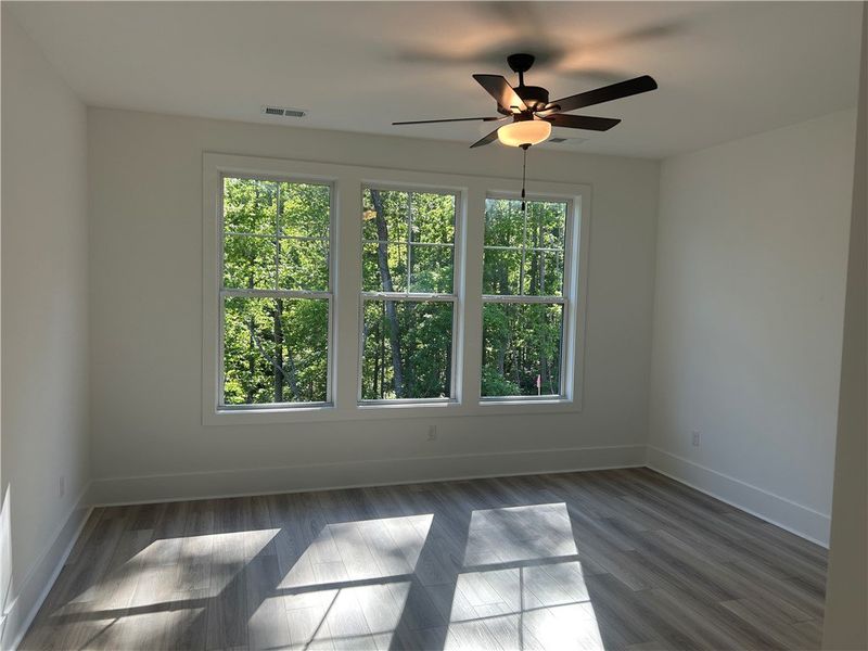 Bright and airy bedroom features expansive windows Bright and airy bedroom features expansive windows