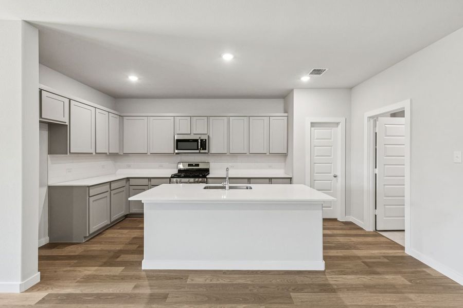 Kitchen in the Oscar home plan by Trophy Signature Homes – REPRESENTATIVE PHOTO Kitchen in the Oscar home plan by Trophy Signature Homes – REPRESENTATIVE PHOTO