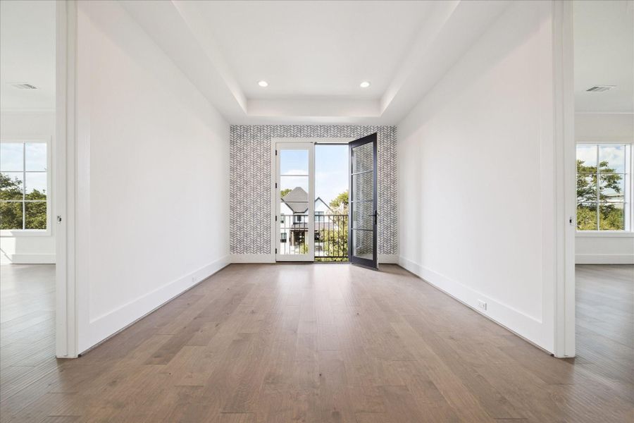 At the top of the stairs, this homework nook or relaxation corner has a Juliet balcony with stylish wallpaper installed by the Sellers. Tray ceiling detail and access to second floor bedrooms. At the top of the stairs, this homework nook or relaxation corner has a Juliet balcony with stylish wallpaper installed by the Sellers. Tray ceiling detail and access to second floor bedrooms.
