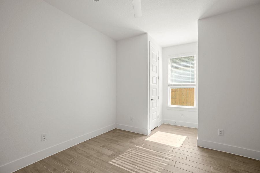 Wood-look tile flooring flows throughout this adaptable bonus room, perfect for any need.