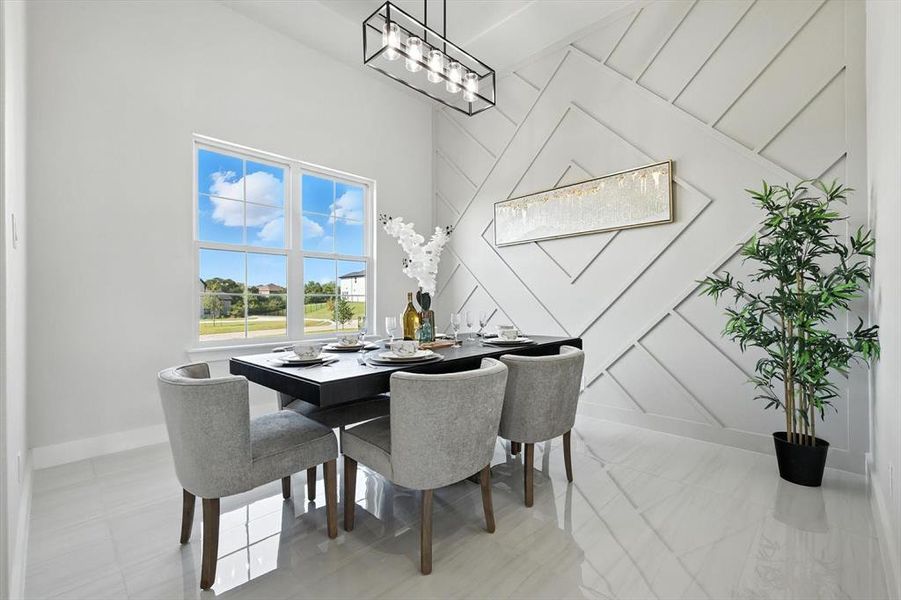 Dining room with a towering ceiling and baseboards Dining room with a towering ceiling and baseboards