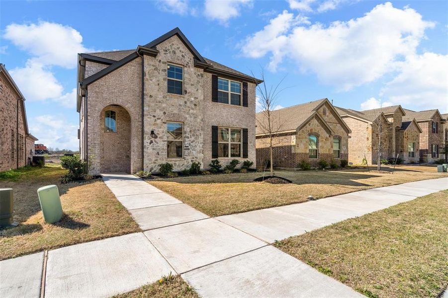 Front exterior of a new home in , Justin, TX, highlighting curb appeal (Image 25). Front exterior of a new home in , Justin, TX, highlighting curb appeal (Image 25).