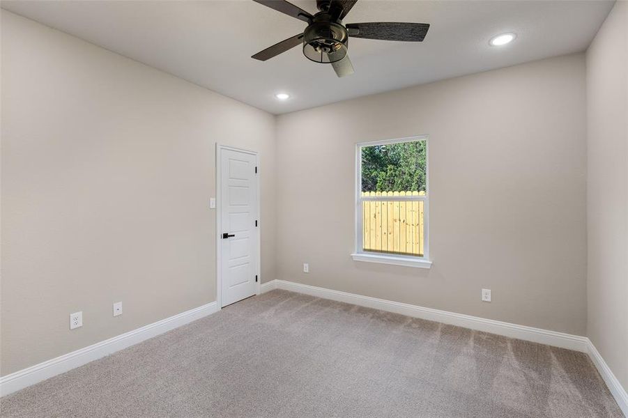 Unfurnished room featuring carpet floors and ceiling fan