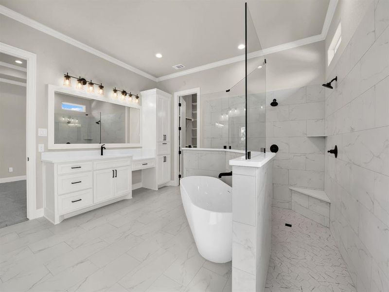 Full bathroom featuring a walk in shower, a soaking tub, marble finish flooring, vanity, and ornamental molding Full bathroom featuring a walk in shower, a soaking tub, marble finish flooring, vanity, and ornamental molding