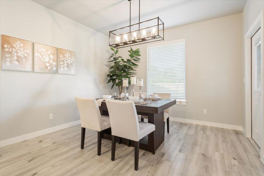 Dining room featuring light wood-style flooring and baseboards Dining room featuring light wood-style flooring and baseboards