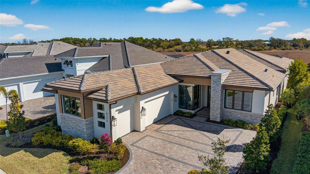 Front exterior of a new home in Wild Blue at Waterside, Sarasota, FL, highlighting curb appeal (Image 22).