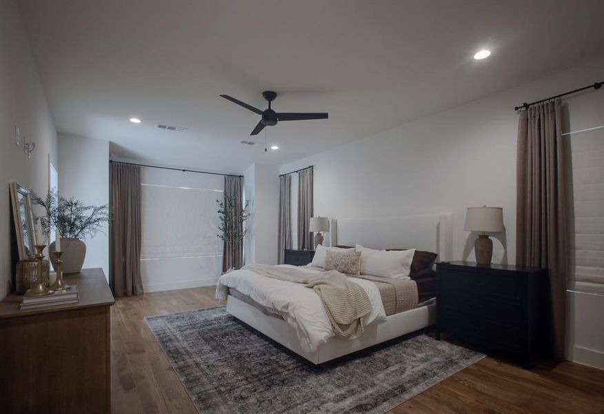 Bedroom featuring ceiling fan and hardwood / wood-style flooring