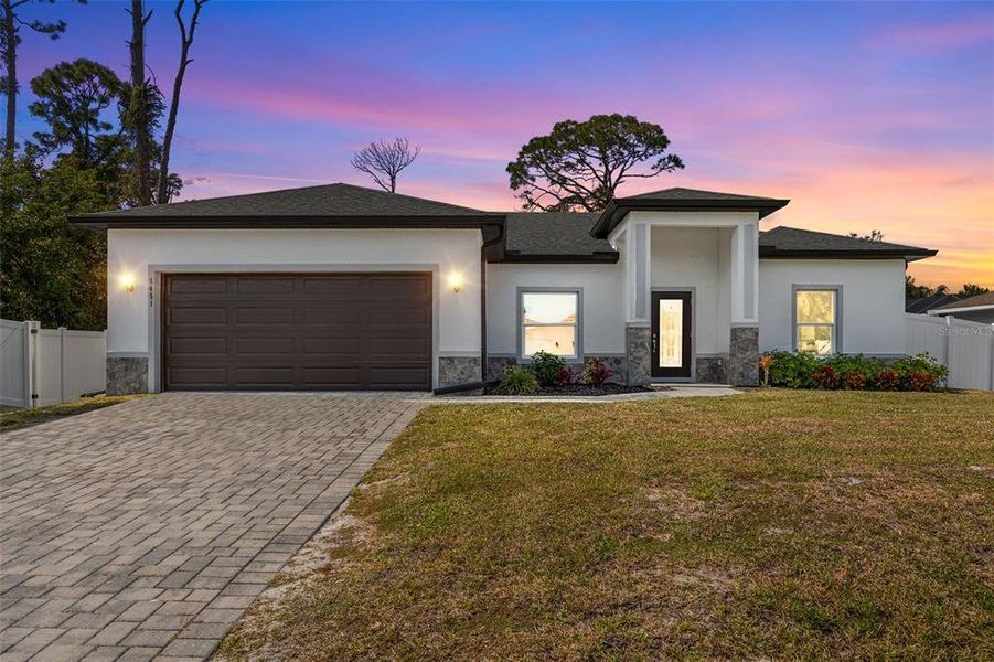 Front exterior of a new home in , North Port, FL, highlighting curb appeal (Image 1). Front exterior of a new home in , North Port, FL, highlighting curb appeal (Image 1).