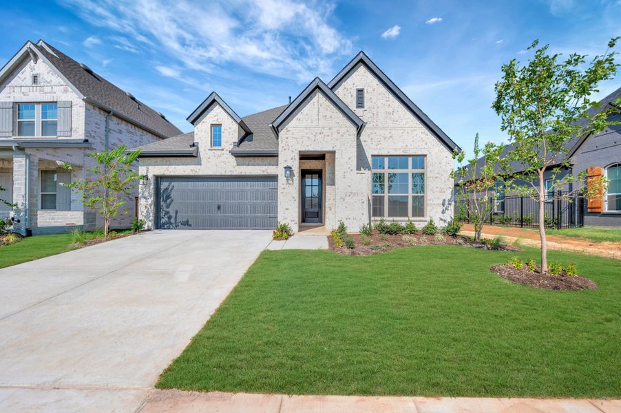 Front exterior of a new home in Sandbrock Ranch, Aubrey, TX, highlighting curb appeal (Image 1). Front exterior of a new home in Sandbrock Ranch, Aubrey, TX, highlighting curb appeal (Image 1).