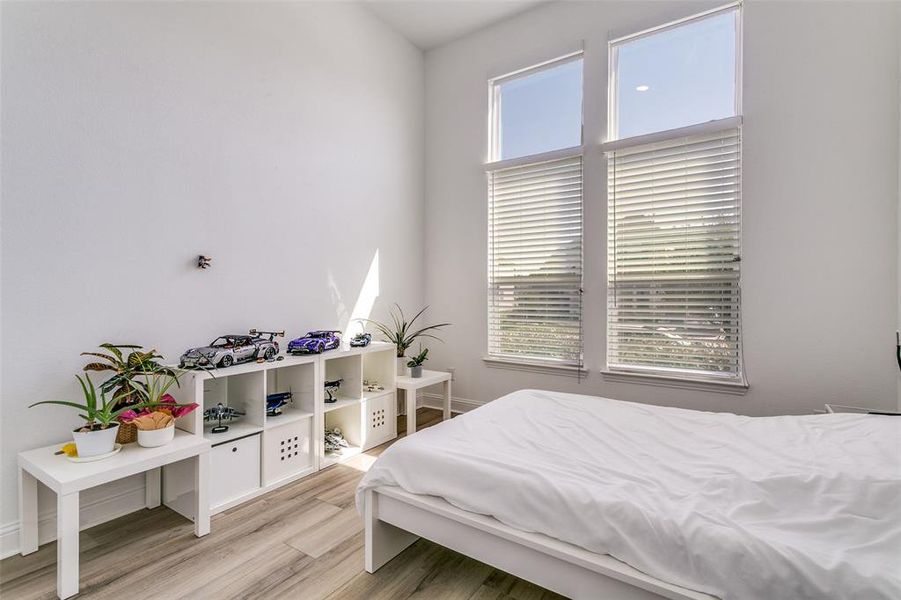 Bedroom with light wood-style flooring and baseboards