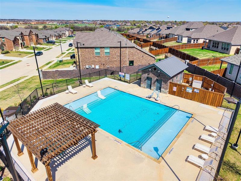 Community pool with a patio area and a residential view Community pool with a patio area and a residential view