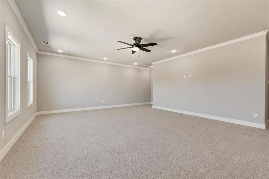 Unfurnished room with light carpet, a ceiling fan, ornamental molding, and recessed lighting